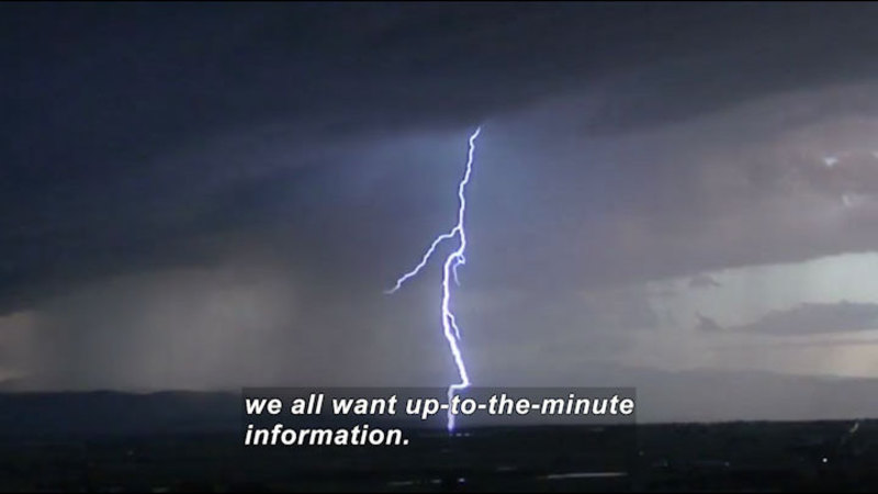 Bolt of lightning arcing from cloud to ground. Caption: we all want up-to-the-minute information.