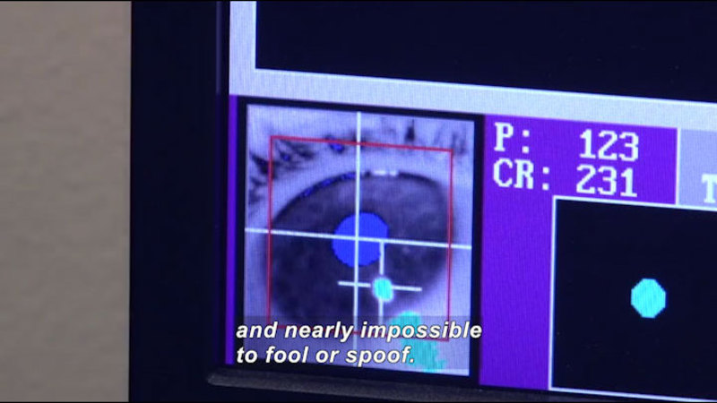 Computer screen showing the closeup of a human eye with crosshairs over the pupil. Caption: and nearly impossible to fool or spoof.