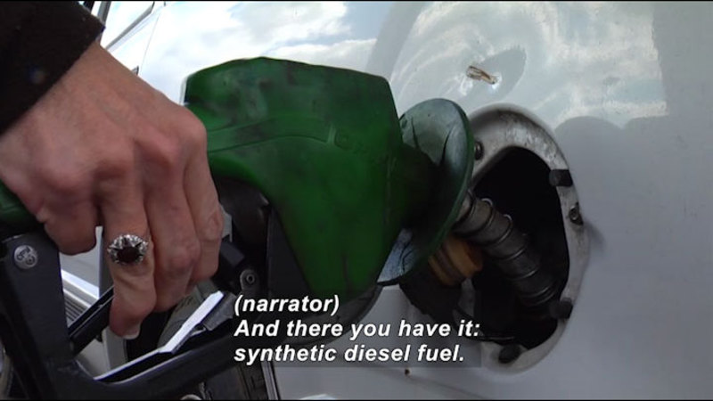 Person pumping fuel into a vehicle. Caption: (narrator) And there you have it: synthetic diesel fuel.