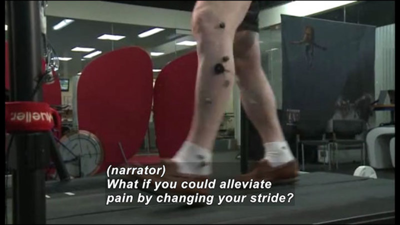 Person walking on a treadmill with sensors attached to their legs. Caption: (narrator) What if you could alleviate pain by changing your stride?