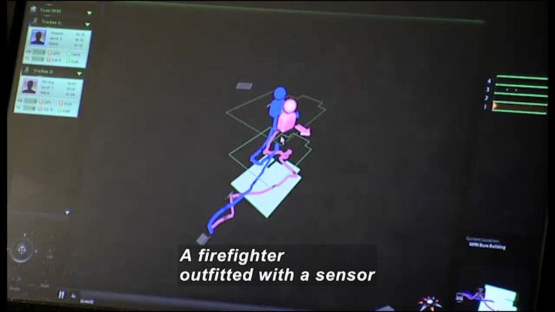 Computer diagram with icons representing two people. The previous paths of the people are also shown. Caption: A firefighter outfitted with a sensor