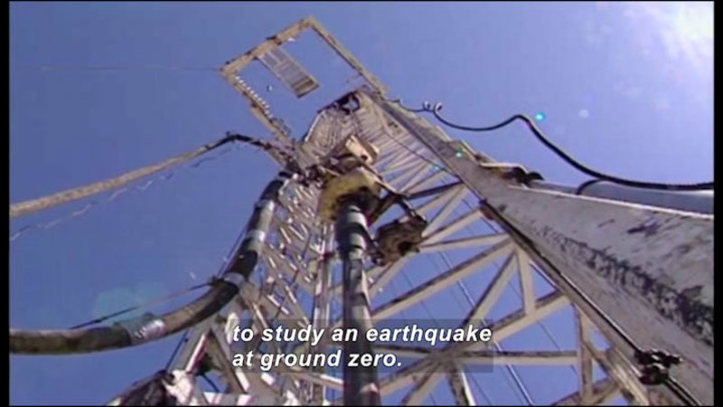 A lattice-work ladder leading to a platform. Instruments and cables are placed on the lattice and platform. Caption: to study an earthquake at ground zero.