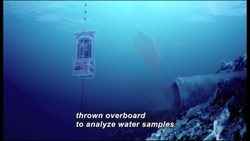 Floating metal measurement instrument in deep blue water. Caption: thrown overboard to analyze water samples