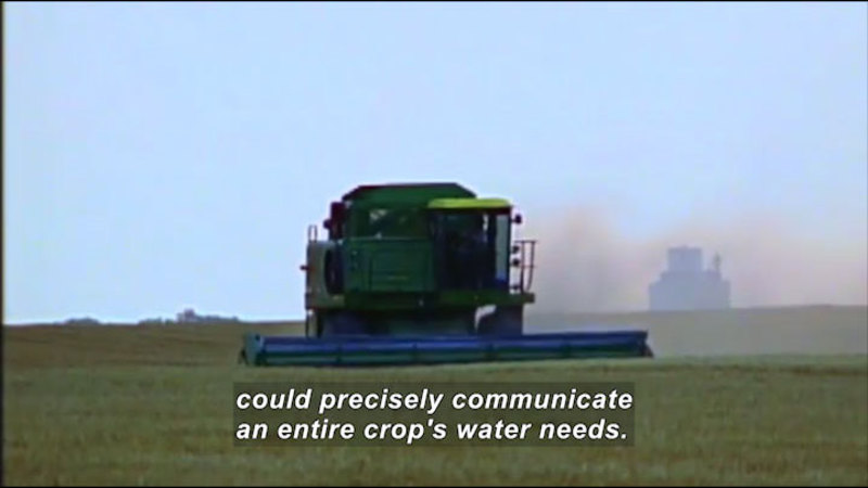 Large industrial machine moving across a cultivated field. Caption: could precisely communicate an entire crop's water needs.