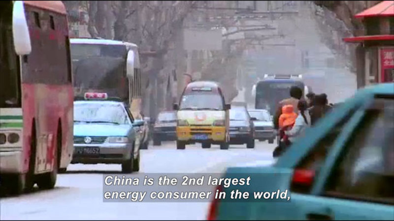 Smoggy city street crowded with vehicles. Caption: China is the 2nd largest energy consumer in the world,