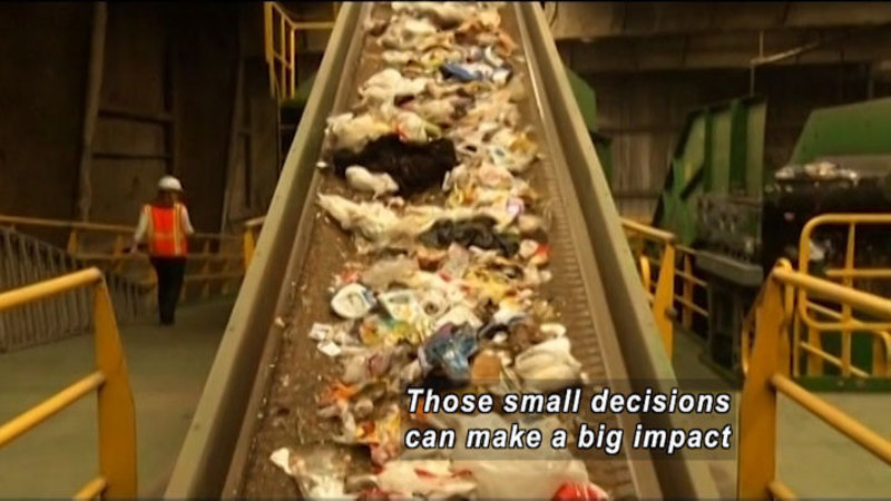 Conveyor belt with trash spread out on it. Caption: Those small decisions can make a big impact