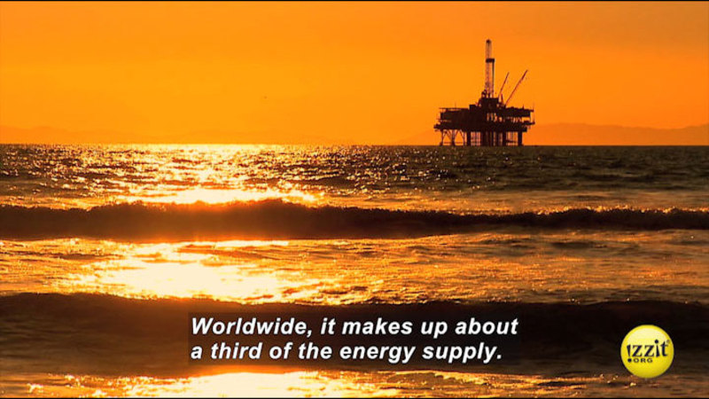 Waves at sunset looking towards an industrial platform held above the water. Caption: Worldwide, it makes up about a third of the energy supply.