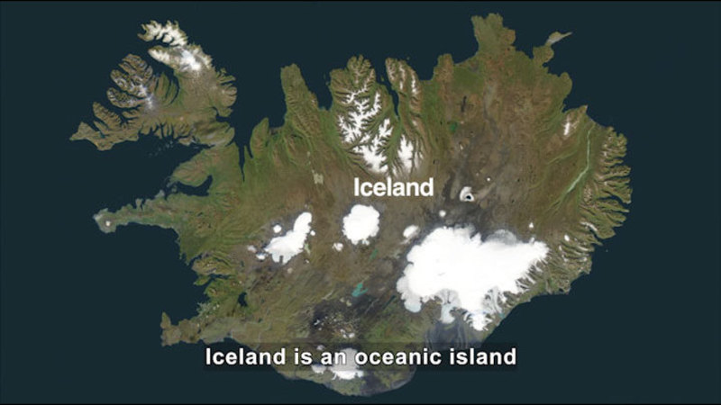Iceland as seen from above. Mostly green with a few central patches of ice and snow. Caption: Iceland is an oceanic island
