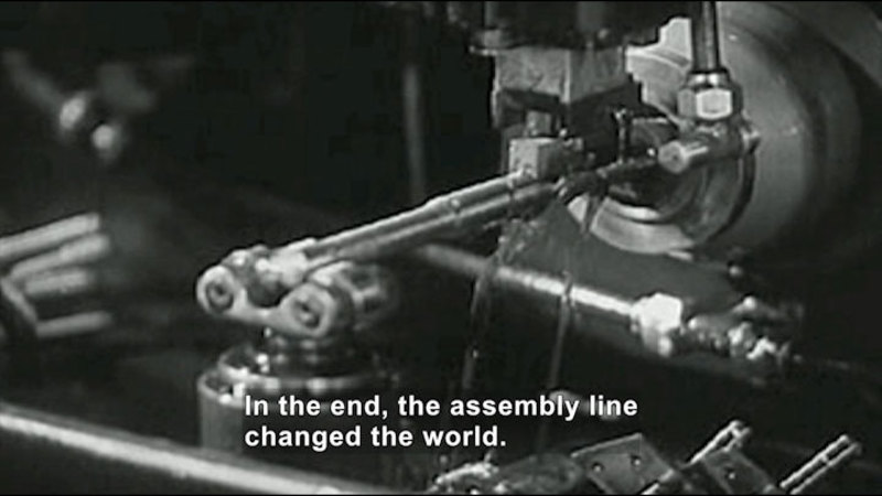 Black and white photo of a complex machine. Caption: In the end, the assembly line changed the world.